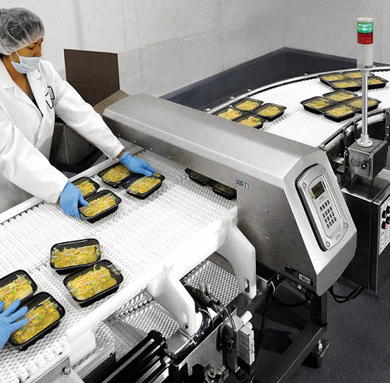 Industrial food metal detector inspecting ready meals